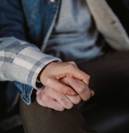 a close up of a person holding the hand of another person